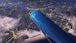 klm royal dutch airlines over city at night