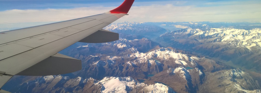 aircraft wing above mountains