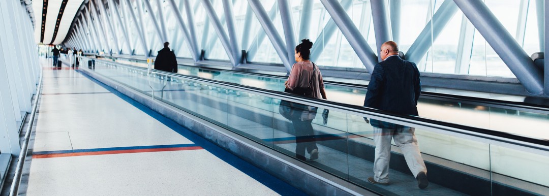 passengers on moving walkway in airport