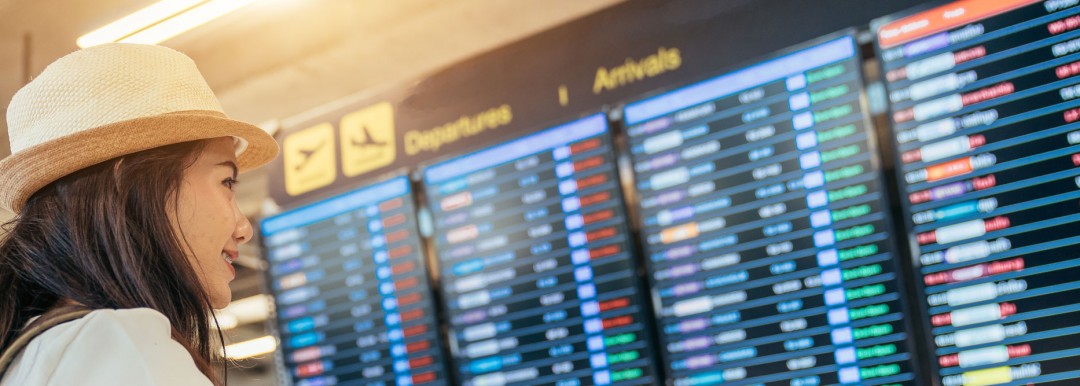 passenger looking at flight arrival screens